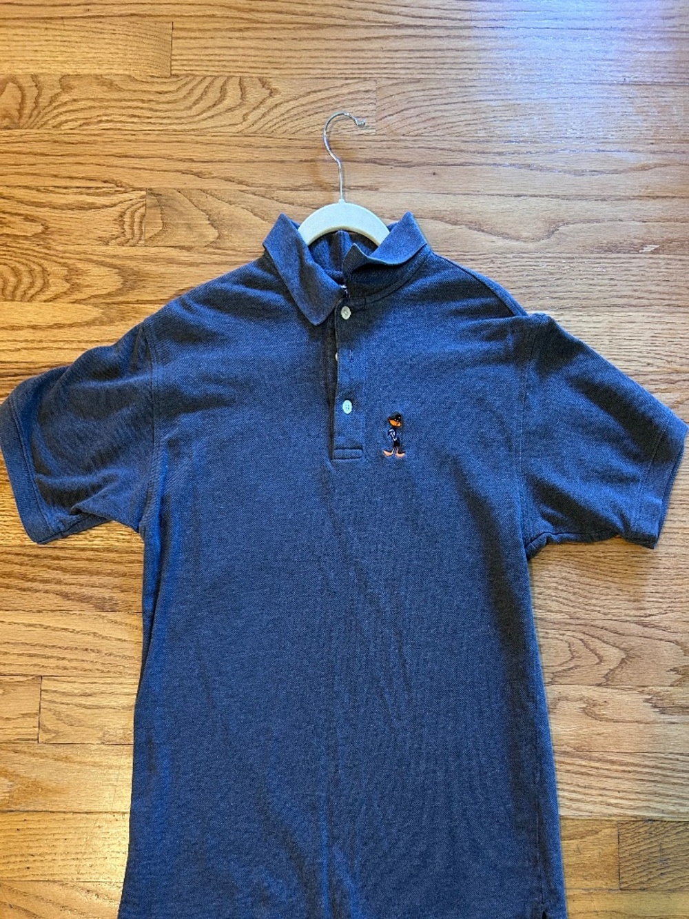 Short-sleeve knit polo featuring embroidered Looney Tunes character Daffy Duck